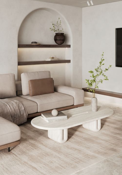 A modern living room with a beige sectional sofa, oval coffee table, shelves with decor items, and minimalist design elements on light wood flooring.