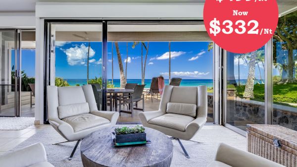 The image shows a modern living space with a view, featuring sleek furniture and a price reduction from $499 to $332 per night.