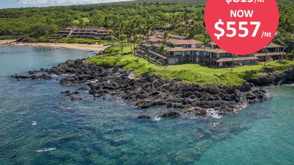 A coastal resort surrounded by greenery and rocky shores, with a promotional bubble indicating a price drop from $819 to $557 per night.