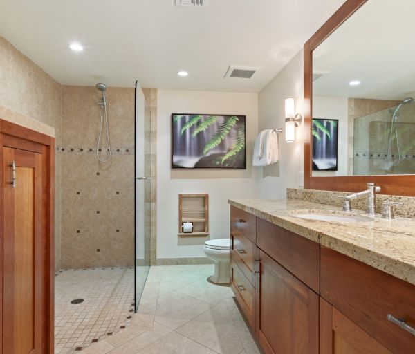The image features a modern bathroom with a shower, toilet, and a double sink vanity, all styled with neutral tones.