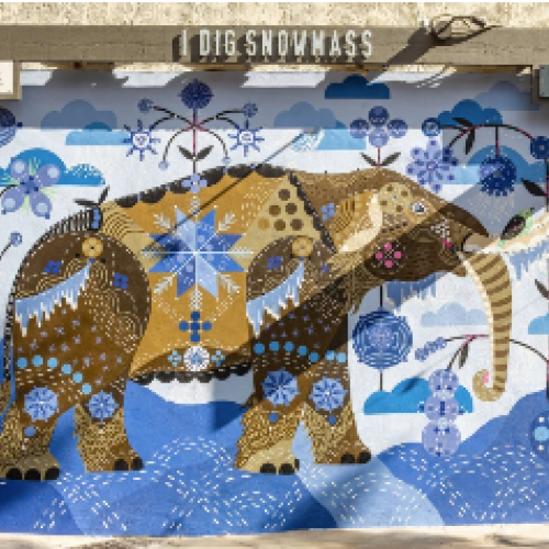 The image features a colorful mural of an elephant surrounded by nature-themed designs and vibrant patterns.