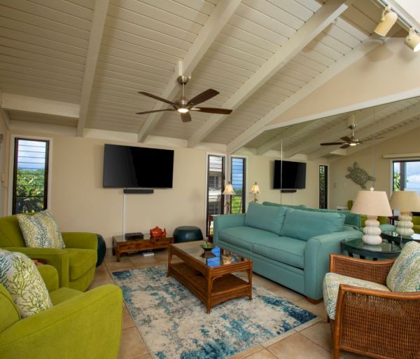 The image shows a stylish living room with a high ceiling, colorful furniture, including green chairs and a light blue couch.