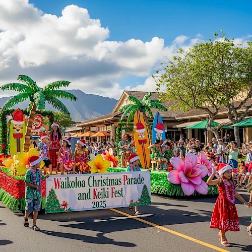 A festive parade on a sunny street with colorful floats, tropical palm props, dancers in bright skirts, and a banner reading &ldquo;Wailoa Christmas Parade and Keki Fest&rdquo; amid cheering crowds.