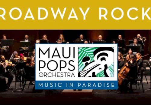 Maui Pops Orchestra performs on stage with a bold &ldquo;Broadway Rocks!&rdquo; banner above them in golden letters.